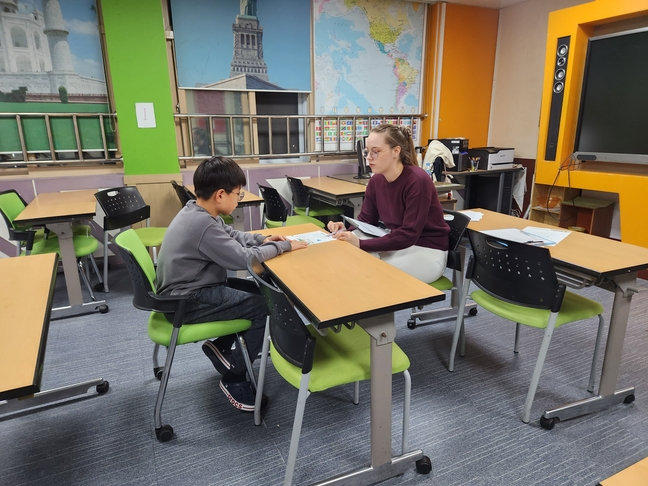 A student sits with a foreign instructor during an after-school English class provided by Danyang District Office of Education in 2023. (Danyang District Office of Education)